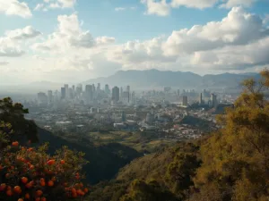 "Aerial view of Los Angeles with downtown skyscrapers, snow-capped San Gabriel Mountains, Getty Center on hillside, palm trees, green hills, blooming winter jasmine, citrus trees with oranges, and distant Hollywood sign on a clear February morning"