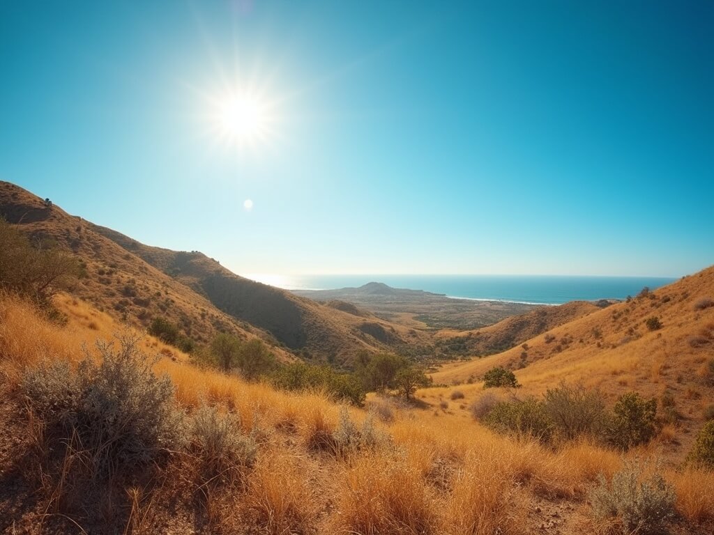 Sunny afternoon landscape in inland Escondido with rolling hills, golden-brown chaparral vegetation, and clear blue sky.