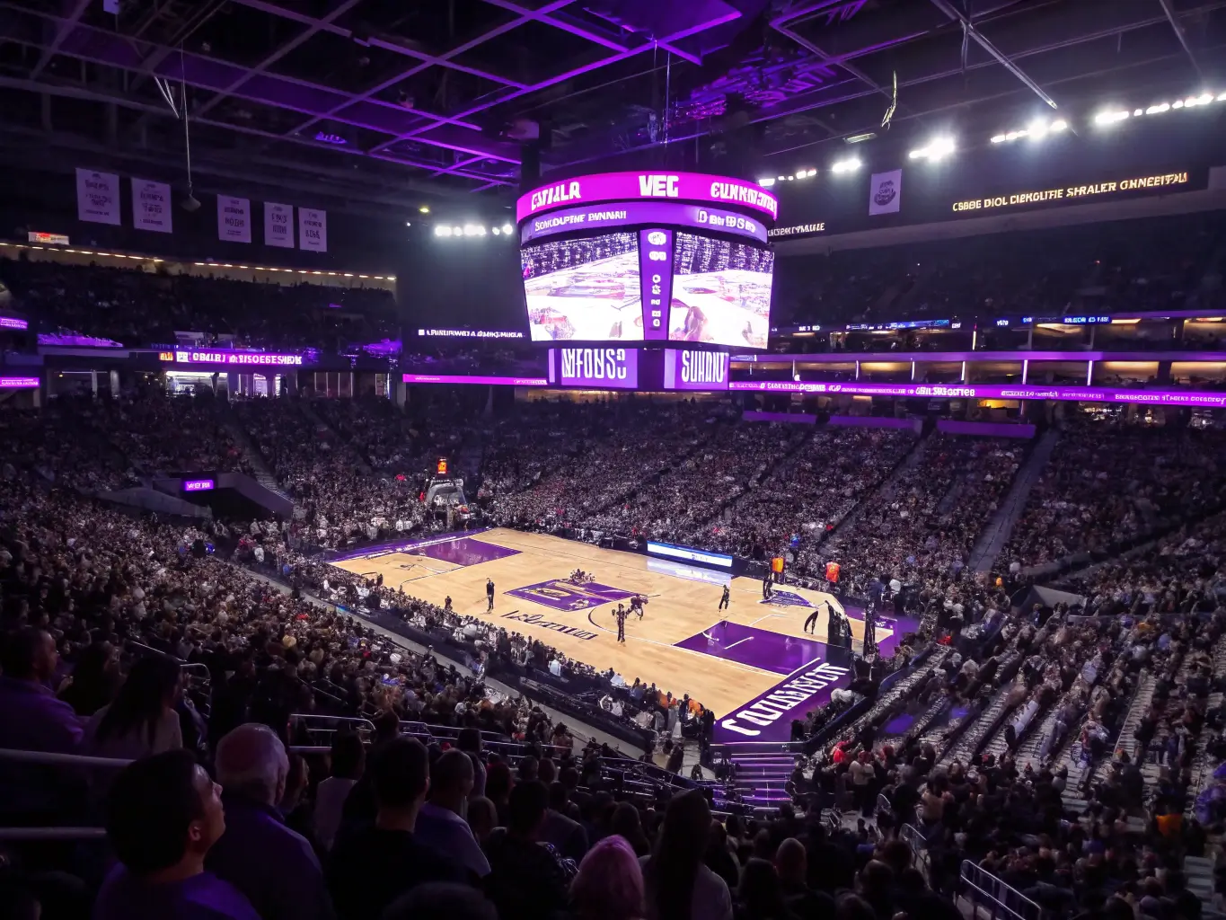 Elevated shot of Sacramento Kings game at Golden 1 Center with purple lighting, crowd filled stands and players in action on the court