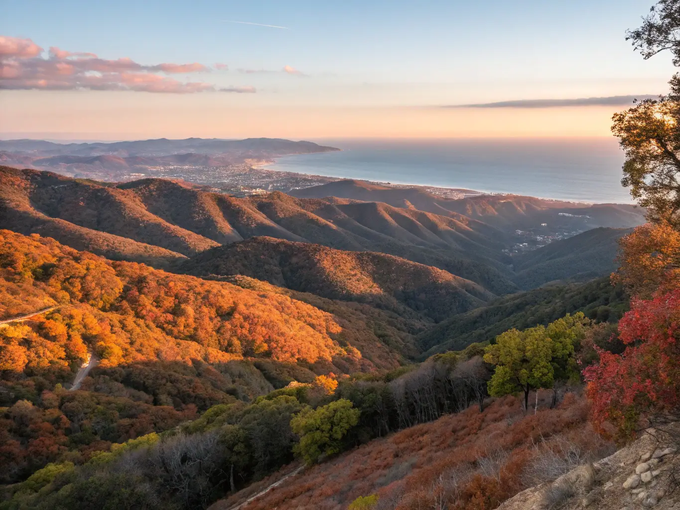 Panoramic view of Los Padres National Forest at golden hour with mountain ranges, autumn colors, clear sky, distant coast, and dramatic lighting