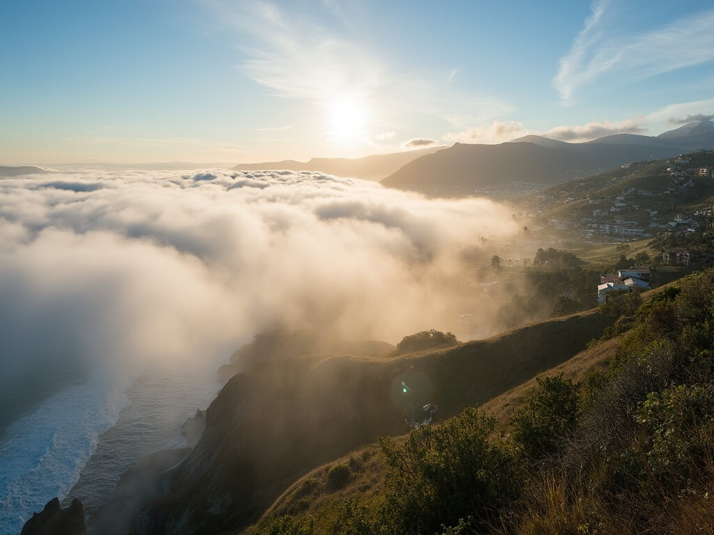 Panoramic view of San Diego's microclimates, showing foggy La Jolla cliffs and sunny Escondido hills