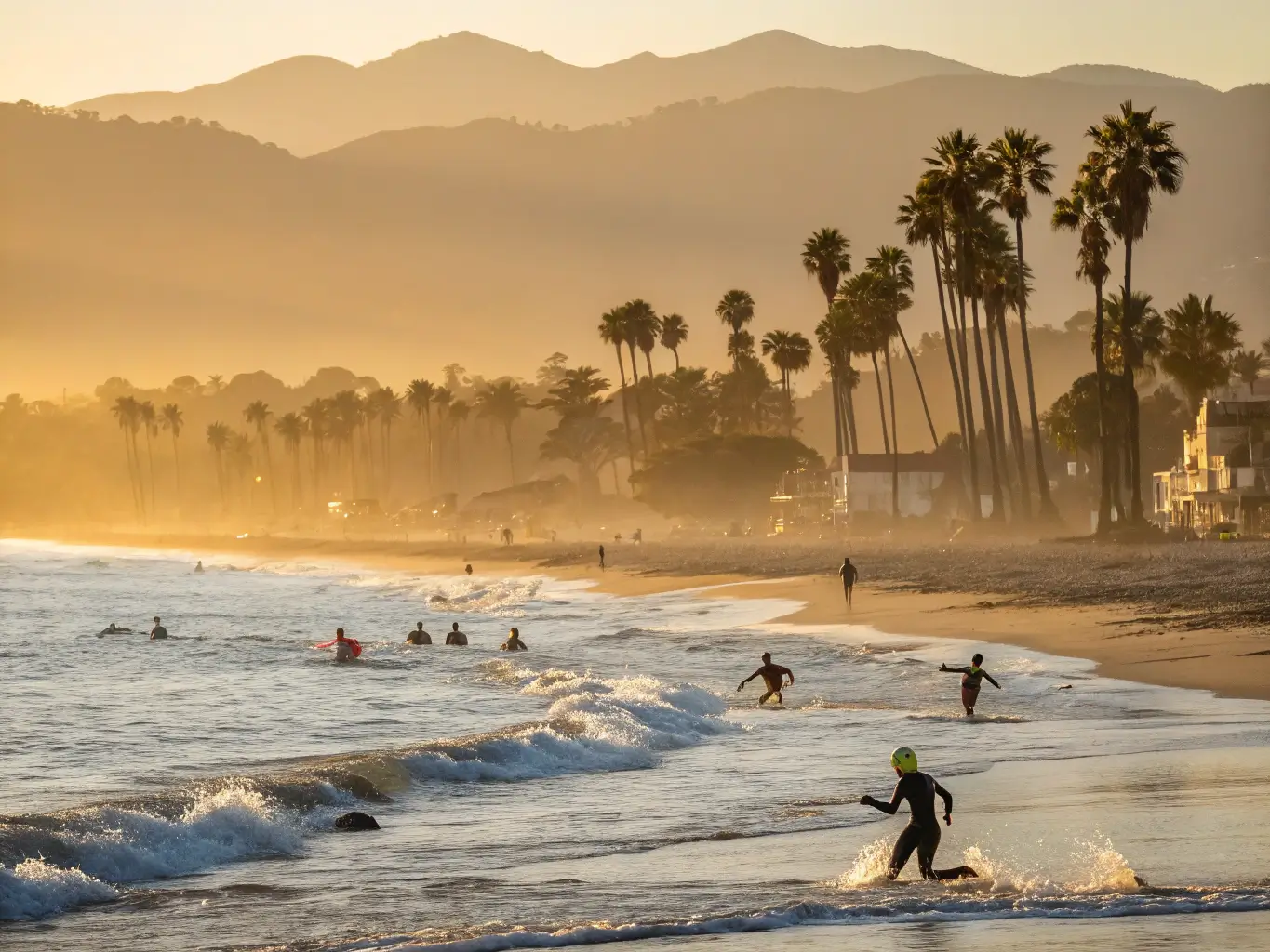 Triathlon participants swimming at East Beach in Santa Barbara during early morning, golden light illuminating palm trees along the coastline