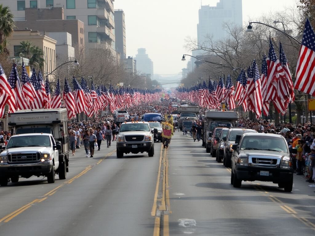 Veterans marching in Central Valley Veterans Day Parade with military vehicles and American flags, surrounded by supportive community crowd, downtown Fresno buildings in the background