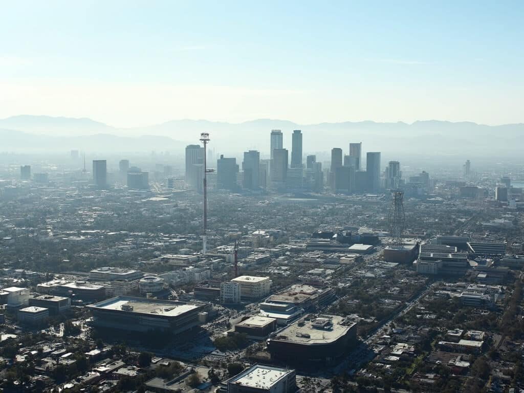 San Jose's urban landscape with tech campuses, modern buildings, clear skies, and distant mountains in May daylight